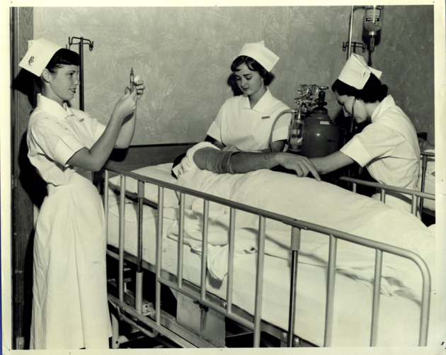 Nursing students carrying out clinical activities on patient